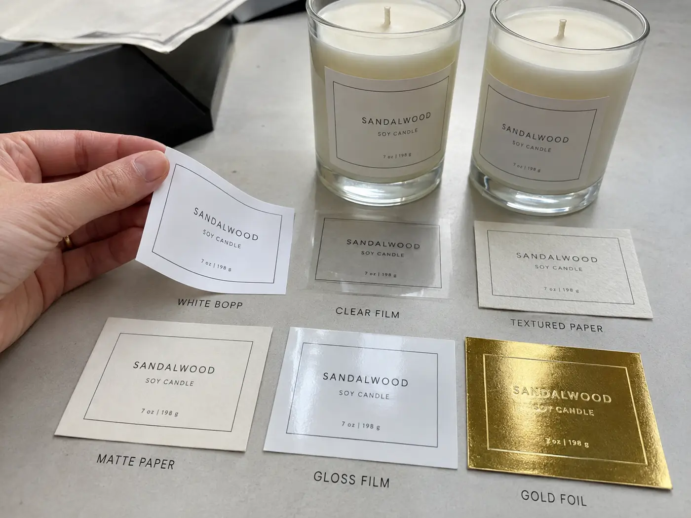 Custom candle label samples in BOPP, paper and gold foil finishes